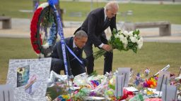 President Barack Obama and Vice President Joe Biden place flowers down during their visit to a memorial to the victims of the Pulse nightclub shooting, Thursday, June 16, 2016 in Orlando, Fla. Offering sympathy but no easy answers, Obama came to Orlando to try to console those mourning the deadliest shooting in modern U.S history. (AP Photo/Pablo Martinez Monsivais)