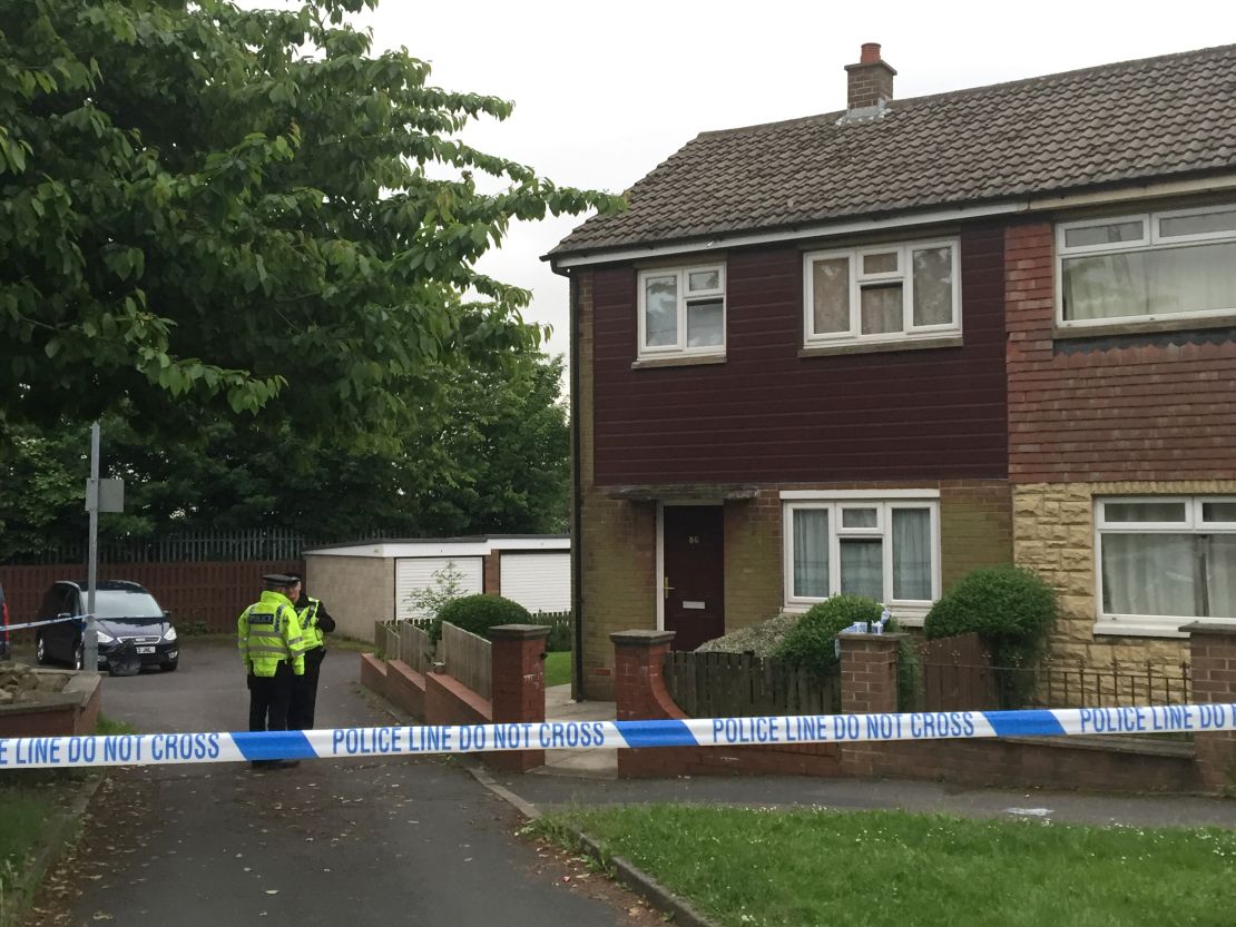 Police search a house near the scene of Jo Cox's killing in Birstall, England.