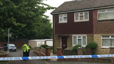 Police search a house near the scene of Jo Cox's killing in Birstall, England.