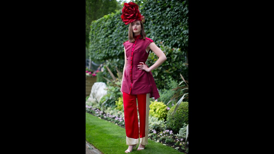 A racegoer poses in a rose hat. 