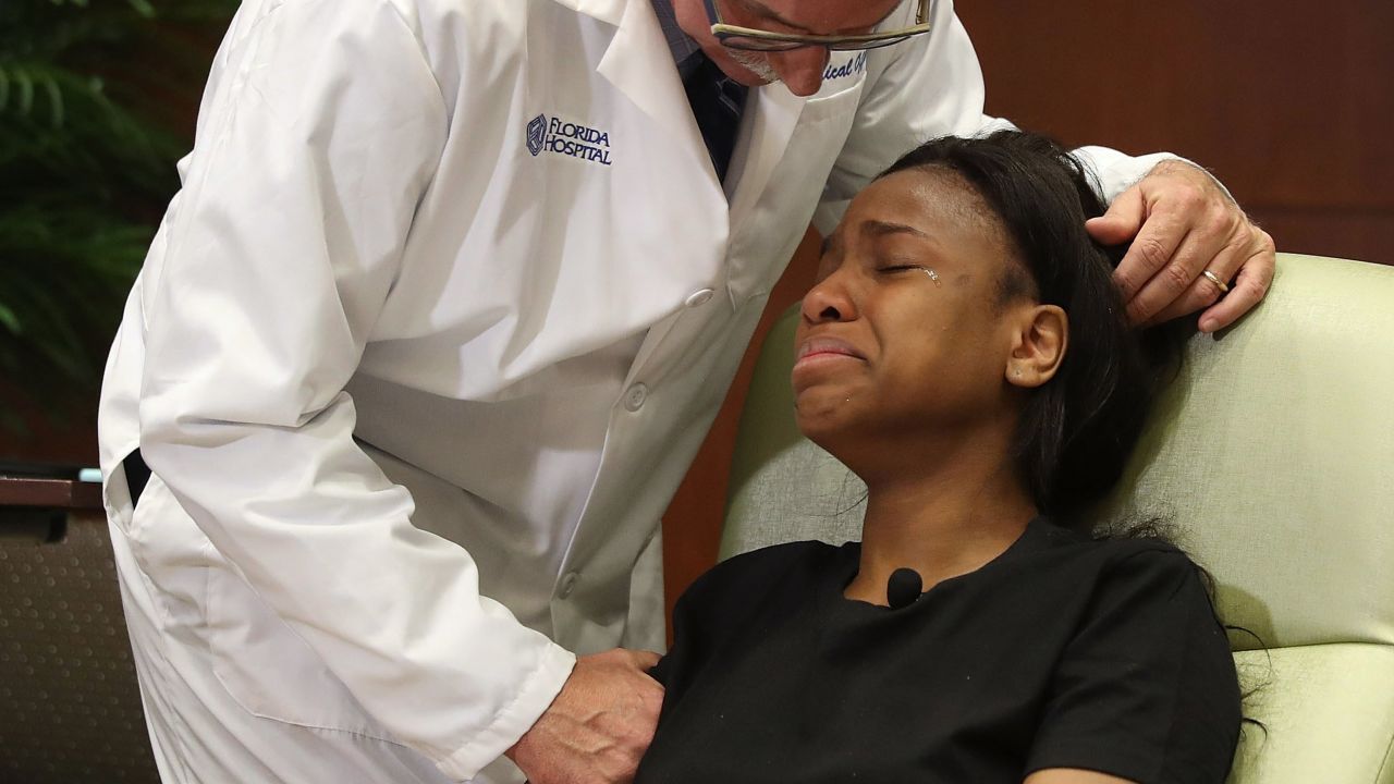 Dr. Neil Finkler comforts survivor Patience Carter.