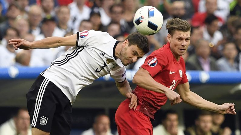 German defender Jonas Hector heads the ball near Poland's Lukasz Piszczek during a goalless draw at Euro 2016.