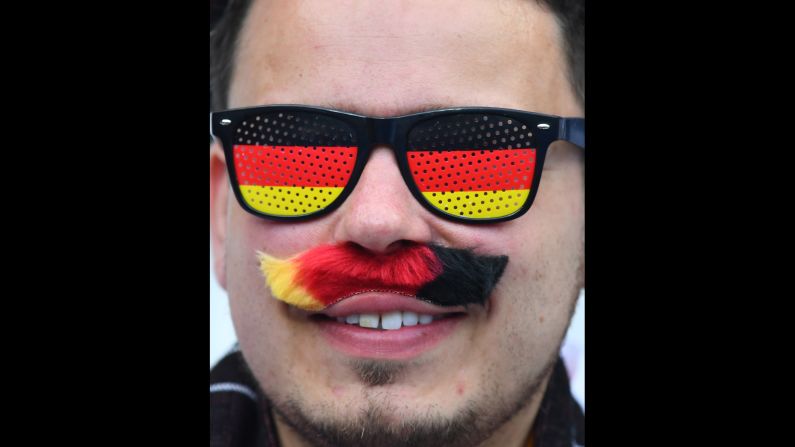 A Germany fan supports his team before the match.