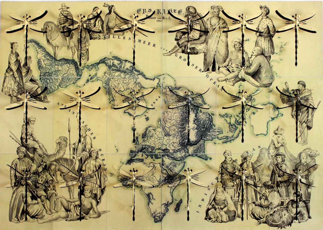 In "Atlante del Popoli" (Atlas of Peoples), 2015, large hand-carved dragonflies superimposed over a map of the world represent the idea of freedom. 
