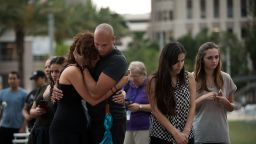 A couple embraces as they visit   a memorial for the victims of the Pulse Nightclub shooting, at the Dr. Phillips Center for Performing Arts, June 14, 2016 in Orlando, Florida.  