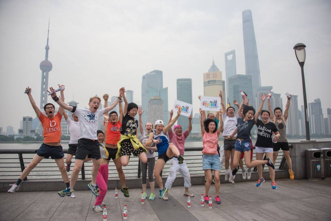 Participants in Shanghai Pride pose for pictures in front of the financial district on June 13, 2015. 