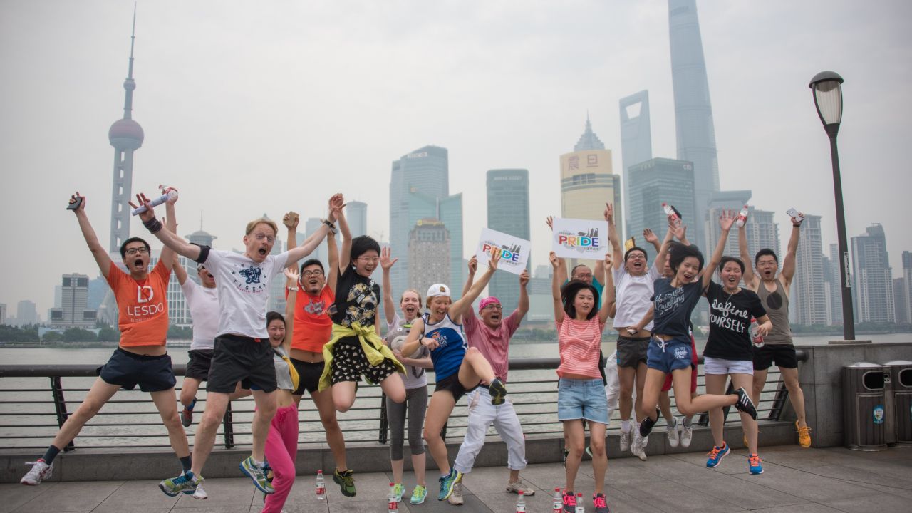 Participants in Shanghai Pride pose for pictures in front of the financial district on June 13, 2015.