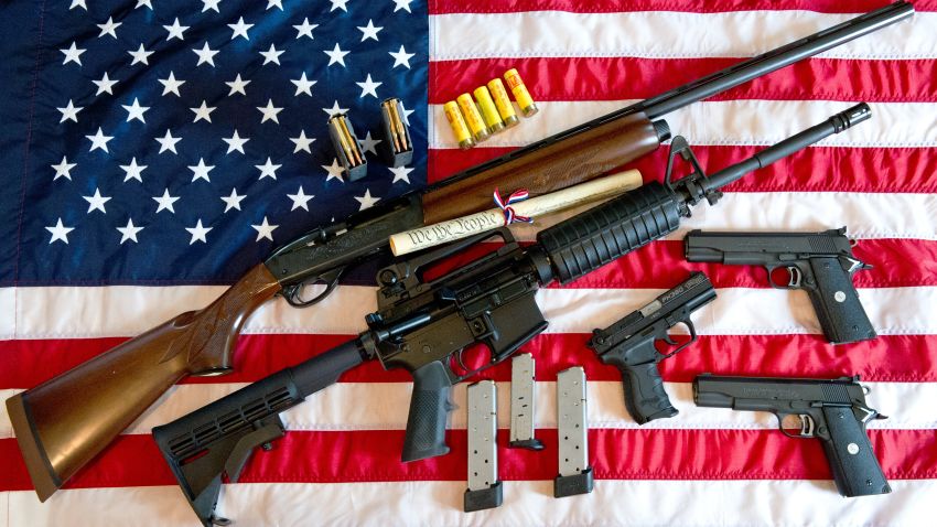 This February 4, 2013 photo illustration in Manassas, Virginia, shows a Remington 20-gauge semi-automatic shotgun, a Colt AR-15 semi-automatic rifle, a Colt .45 semi-auto handgun, a Walther PK380 semi-auto handgun and various ammunition clips with a copy of the US Constitution on top of the American flag. US President Barack Obama Monday heaped pressure on Congress for action "soon" on curbing gun violence. Obama made a pragmatic case for legislation on the contentious issue, arguing that just because political leaders could not save every life, they should at least try to save some victims of rampant gun crime.