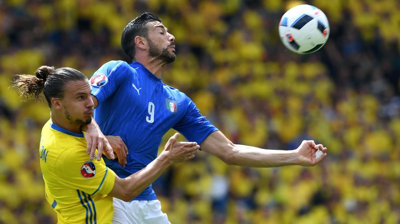 Pelle and Swedish defender Erik Johansson compete for a ball.