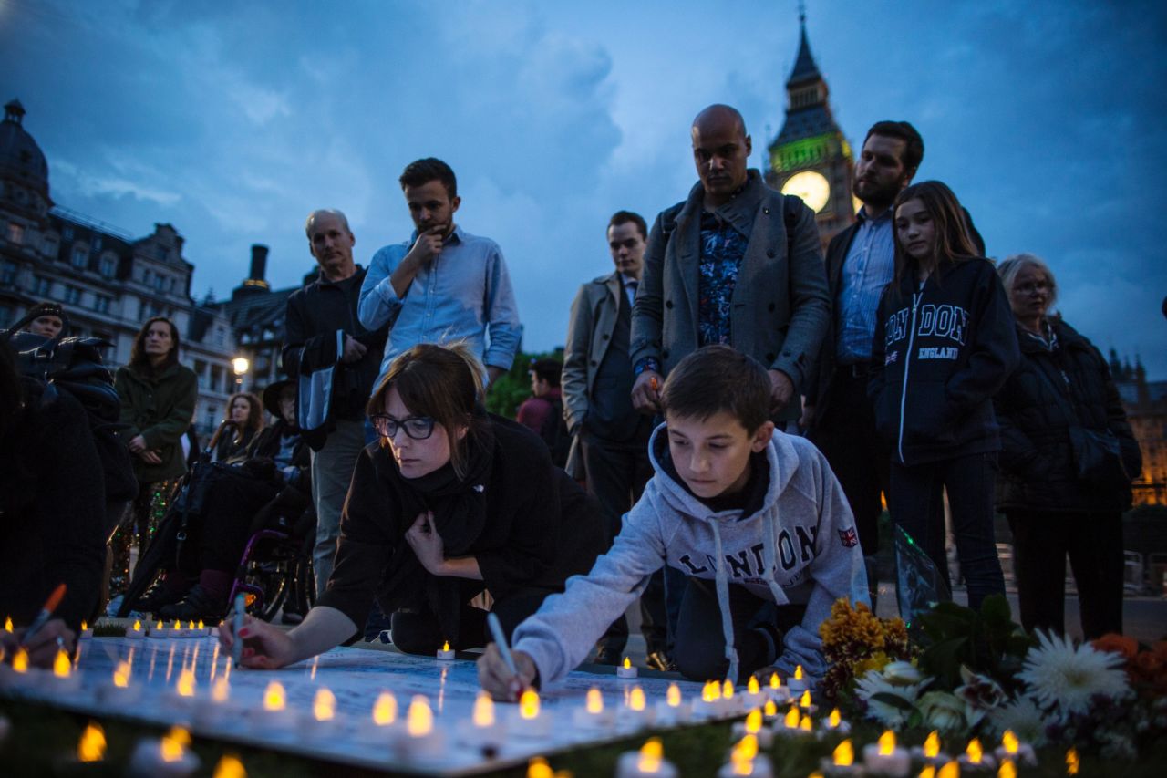 People sign messages on Parliament Square on June 16.