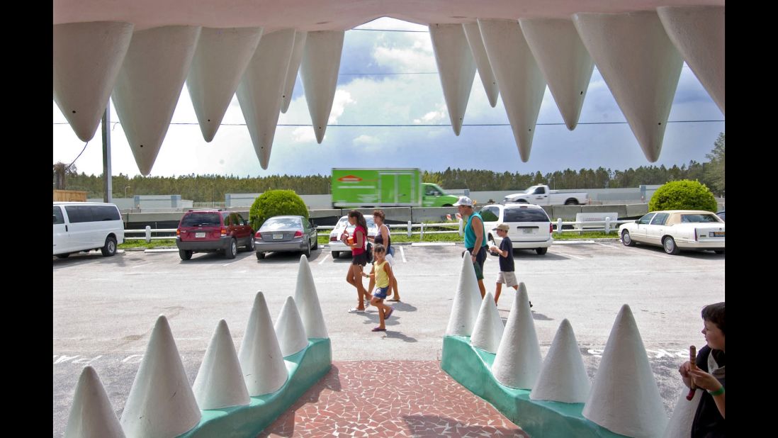 People walk past Gatorland's signature entrance in 2004.