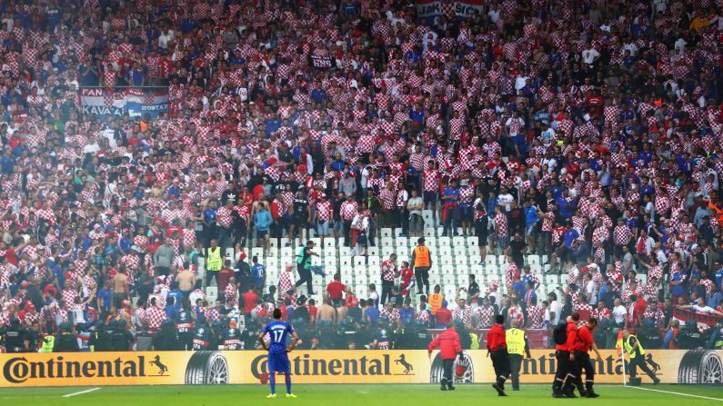 Croatian fans are seen in the crowd as the flares are taken off the field.