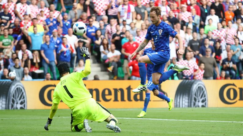 Rakitic chips his goal over Czech goalkeeper Petr Cech.