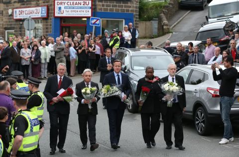 British Prime Minister David Cameron, center, joins other political leaders in paying their respects to slain Parliament member Jo Cox on Friday, June 17. Cox, 41, was stabbed and shot in Birstall, England, after a meeting with her constituents. A 52-year old man, Tommy Mair, is being held in police custody in connection with her death.