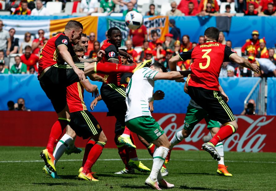 Belgium's Toby Alderweireld, left, hits Ireland's Shane Long in the head with his boot.