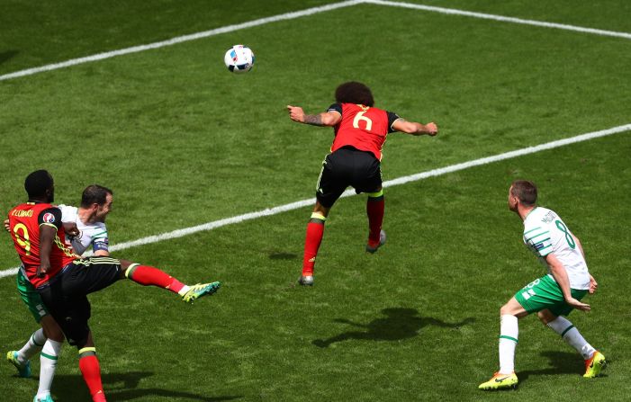 Axel Witsel of Belgium heads the ball to score his team's second goal.