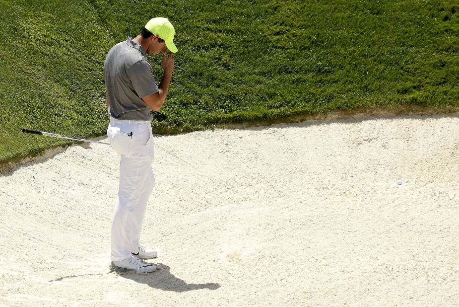 Rory McIlroy reacts after leaving his first bunker shot in the sand on the ninth hole during the second round on June 18.