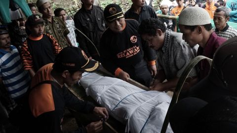 Indonesian villagers prepare for the funeral of a landslide victim in Banjarnegara on Sunday.