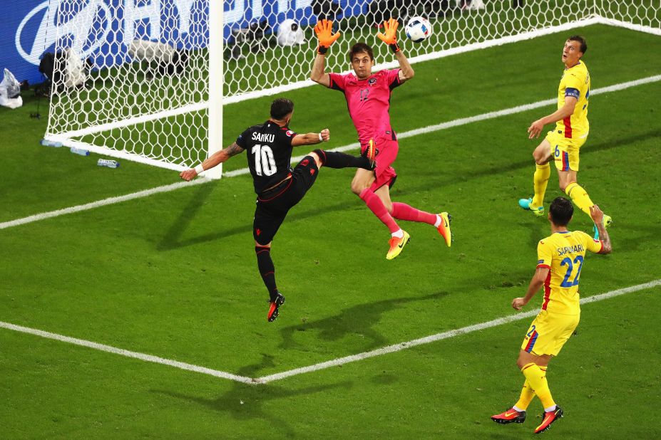 Armando Sadiku, first left, of Albania heads the ball to score past Ciprian Tatarusanu of Romania.