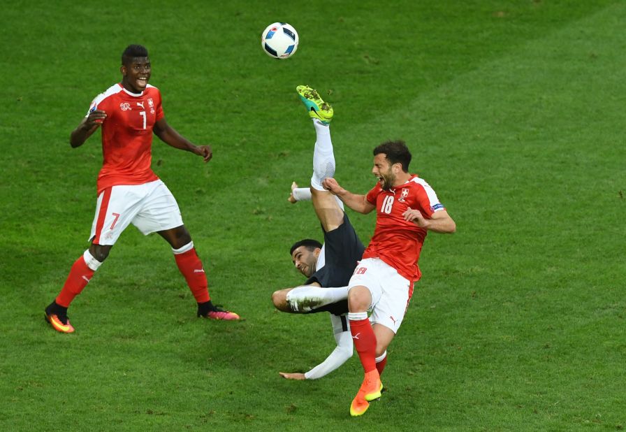  Adil Rami of France attempts an overhead kick while Admir Mehmedi of Switzerland tries to block during their match at Stade Pierre-Mauroy on Sunday in Lille, France. The game ended in a 0-0 draw. 