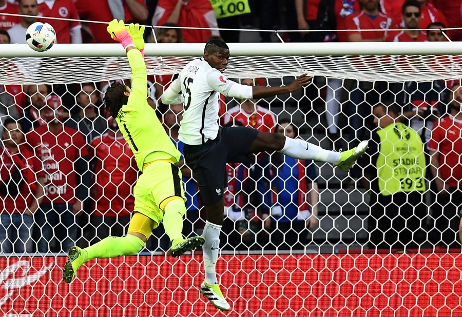 Switzerland's goalkeeper Yann Sommer jumps for the ball against France's midfielder Paul Pogba.