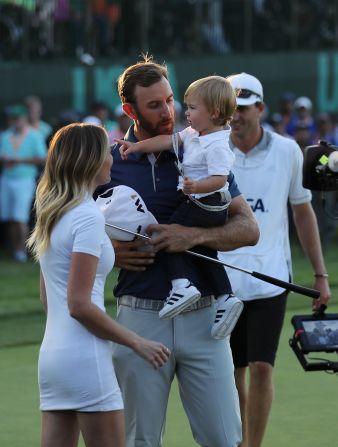 Johnson of the United States celebrates with partner Paulina Gretzky and son Tatum on June 19. 