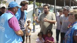 Theo James talks to refugees at a camp at Alexanderia in Greece, which is home to 812 refugees, the majority of them from Syria and Iraq.