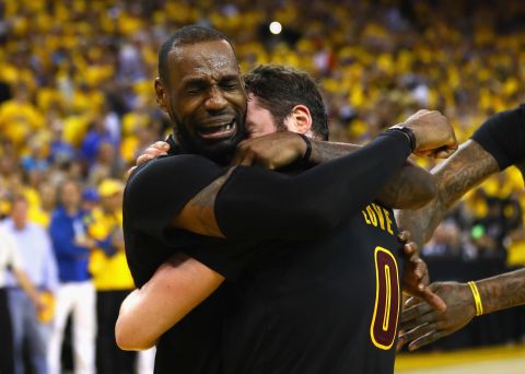 James cries and hugs and teammate Kevin Love after defeating the Golden State Warriors 93-89 in Game 7 of the 2016 NBA Finals.