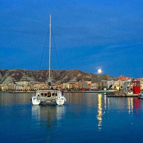 The strawberry mooni seen in Europe too, like this image of the moon over the waters of the Port of Crotone in Italy on June 20.