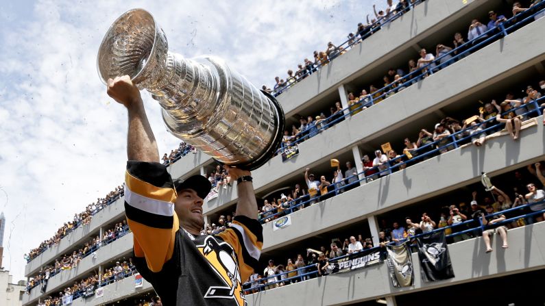 Kris Letang, an All-Star defenseman for the Pittsburgh Penguins, holds up the Stanley Cup during a victory parade in Pittsburgh on Wednesday, June 15. The Penguins defeated San Jose in six games last week to claim the title.