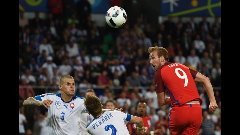 England striker Harry Kane heads the ball toward goal.