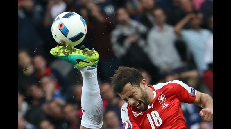 Swiss forward Admir Mehmedi heads the ball near a French opponent's boot during a Euro 2016 game in Lille, France, on Sunday, June 19.