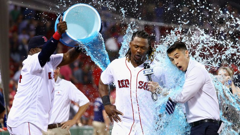 David Ortiz douses Boston teammate Hanley Ramirez and NESN reporter Gary Striewski after the Red Sox defeated Baltimore on Wednesday, June 15.