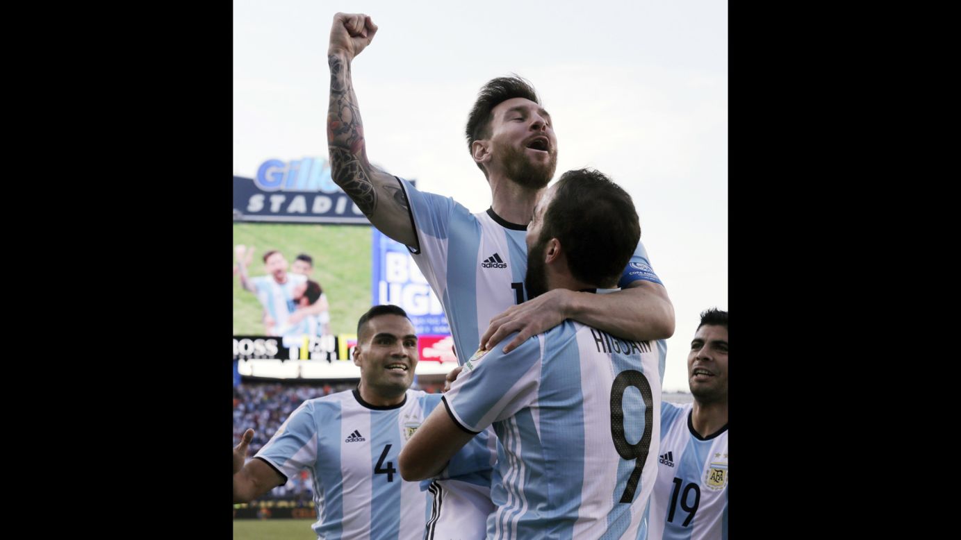 Argentina star Lionel Messi is held by teammate Gonzalo Higuain after the two linked up for the opening goal against Venezuela on Saturday, June 18. Argentina won the match 4-1 and advanced to the semifinals of the Copa America. 