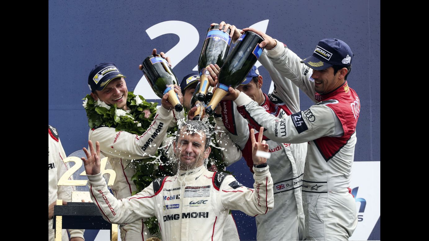 Romain Dumas has champagne dumped on his head after he and Porsche teammates Neel Jani and Marc Lieb won the 24 Hours of Le Mans on Sunday, June 19. The endurance race is held annually in western France.