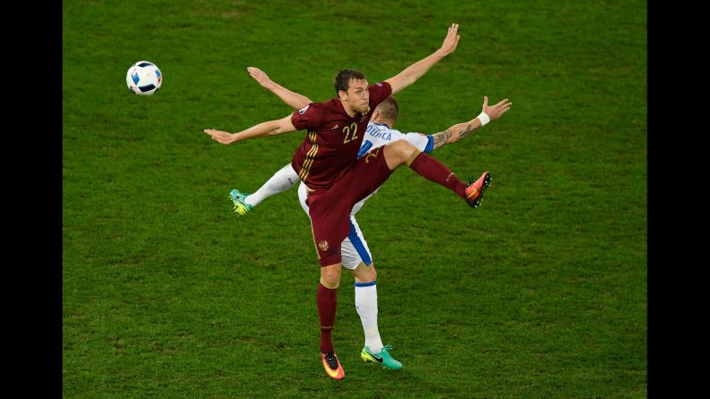 Russia's Artem Dzyuba, front, and Slovakia's Jan Durica compete for a ball Wednesday, June 15, during a match at Euro 2016. Slovakia won 2-1.