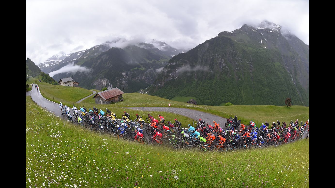 Cyclists ride through mountains during the Tour of Switzerland on Thursday, June 16.