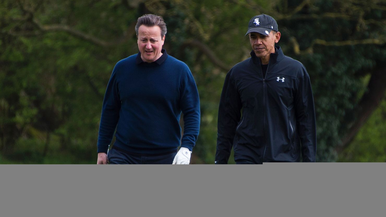 US President Barack Obama (R) talks with British Prime Minister David Cameron (L) as they walk onto the 3rd green at The Grove Golf Course near Watford in Hertfordshire, north of London, on April 23, 2016.  