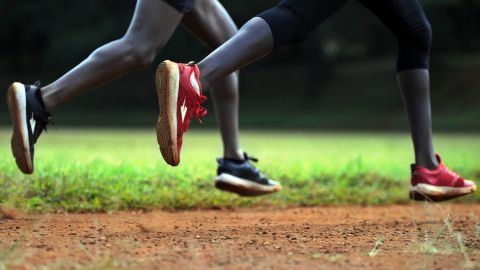 Young athletes run on a dirt track during a trial session of prototypes of the 'enda iten' - a running sneaker created in Kenya and named after the east african country's renowned cradle of athletics talent Iten, in Kenya's north-rift town of Eldoret on June 10, 2016.
Made in the colours of Kenya's national flag, 'enda iten' (swahili for Go!-Iten) is in the running to earn a place as a home-grown flagship of Kenya's high flying performance in international athletics with hopes of a debut in the forthcoming Olympic's in Rio, Brazil -2016. Founded in 2015 by Kenyan, Navalayo Osembo-Ombati with American entrepreneur Weldon Kennedy, 'enda iten' is infused with the spirit of harambee, a Swahili term that refers to coming together as a community to accomplish a goal and embodying the founders' intent for benefit from Kenya's culture of, and international success at distance running by having a percentage of shoe's sales profits donated to fund projects aimed at improving access to clean water, sanitation, healthcare and education. / AFP / TONY KARUMBA        (Photo credit should read TONY KARUMBA/AFP/Getty Images)