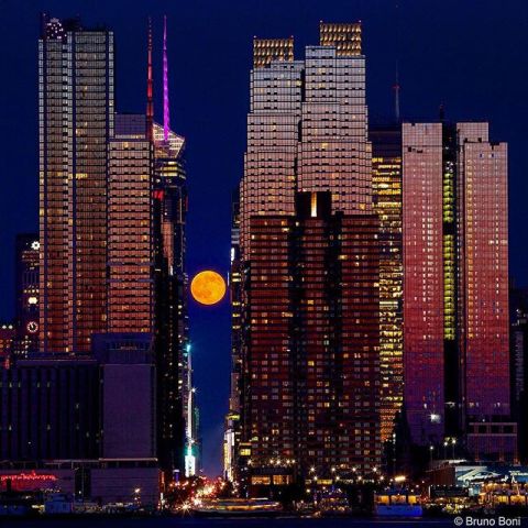 The summer solstice featured a full "strawberry" moon. The name comes from the belief that strawberry-picking season is at its peak during this time, according to the Farmer's Almanac. The moon hovered above 42nd Street in New York City as the skyline glowed from the setting sun on Monday.