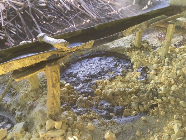 The molten sulfur flows down a wooden sluice where filters help purify the liquid.