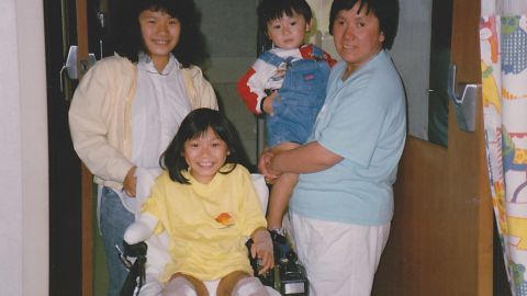 Kellie Lim with her mother, brother and sister after surgery to amputate her legs and right arm.