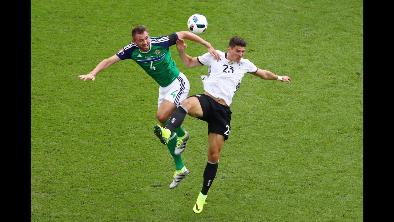 Gomez and Gareth McAuley compete for a header.