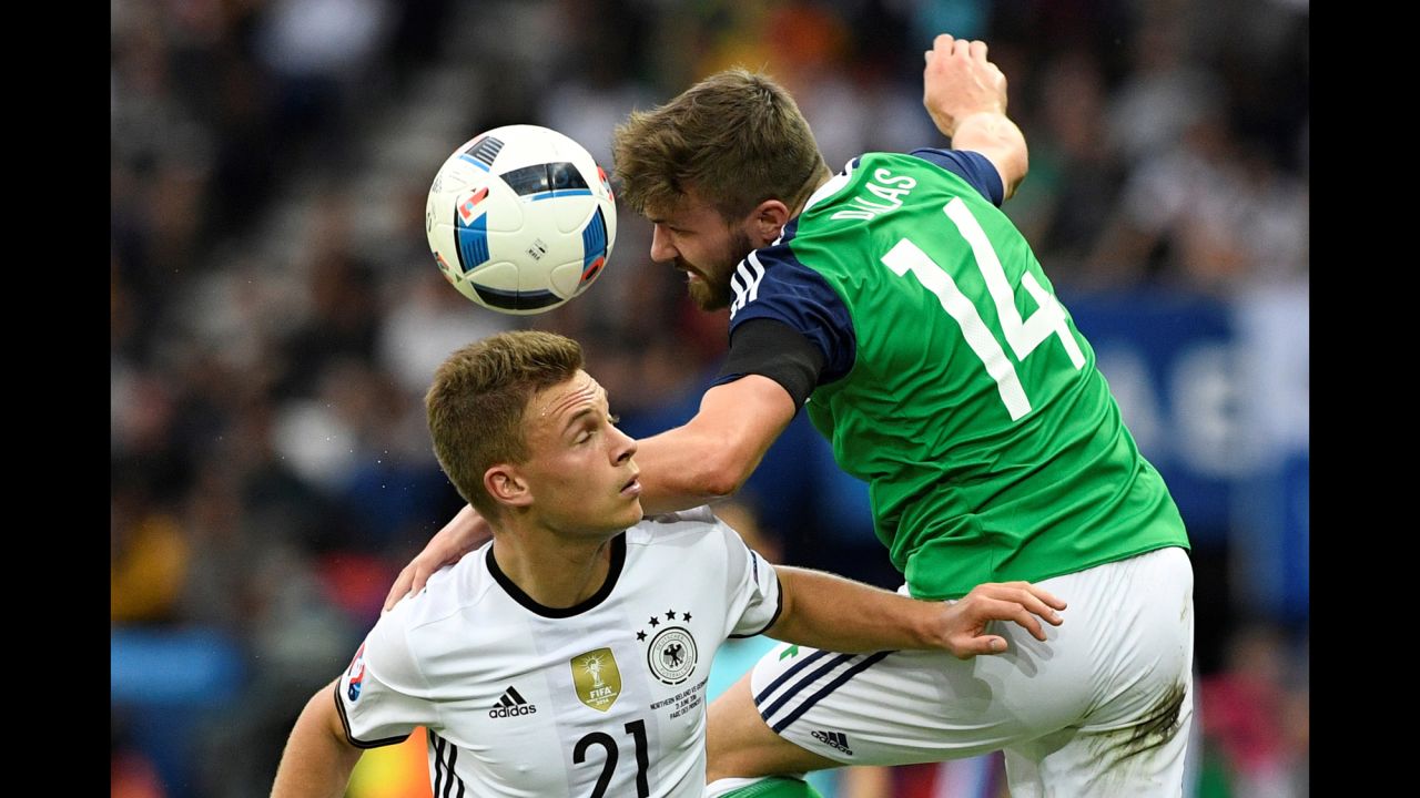 Germany's Joshua Kimmich and Northern Ireland's Stuart Dallas battle for possession.