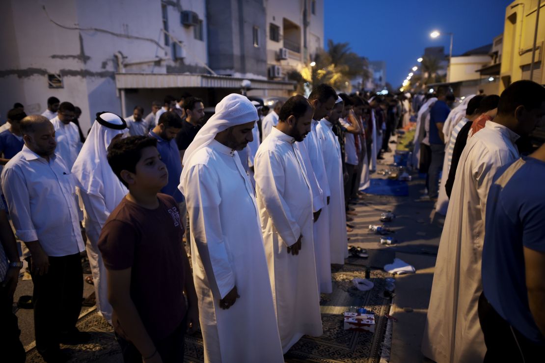 Bahraini demonstrators pray  following a protest against the revocation of the citizenship of  Qassim on June 20, 2016. 