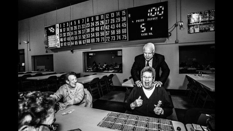 U.S. Sen. John McCain surprises a bingo hall patron in Manchester, New Hampshire, where presidential candidate Lindsay Graham was campaigning in October.