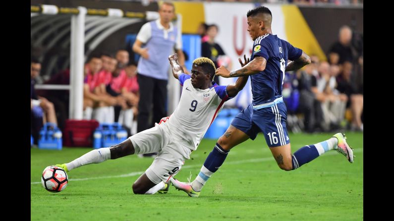 Gyasi Zardes slides to win possession for the United States.