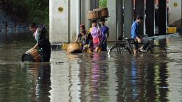 Indians wade through a flooded street Tuesday in Mumbai.