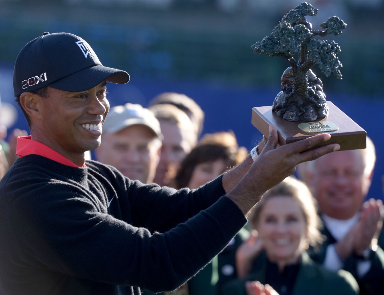 Woods holds the trophy for the Farmers Insurance Open at Torrey Pines in January 2013, where he clinched his 75th PGA Tour title. 