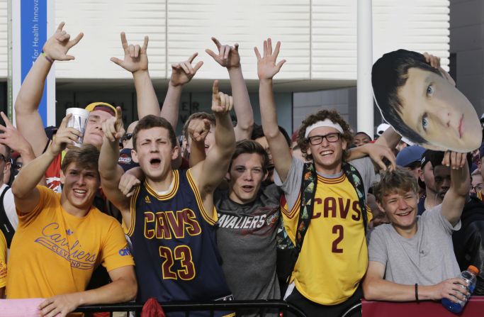 Fans cheer for the start of the parade.